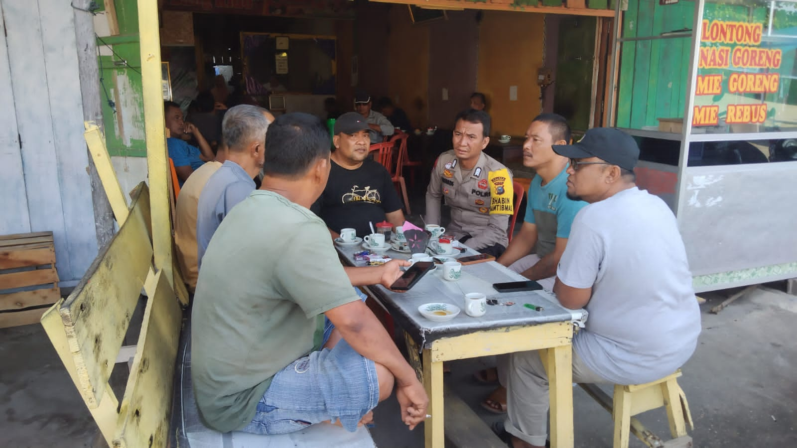 Jelang Pilkada, Bhabinkamtibmas Polsek Kuantan Hilir Ajak Pecinta Kopi di Pasar Usang Baserah Dukung Pilkada Damai